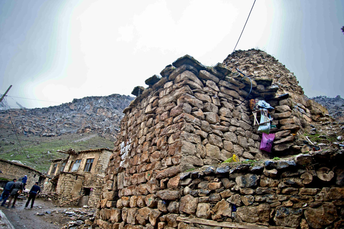 Once we are out, people in the house across the church wave and we are invited to drink tea at Mehmet Bey's home. Villagers watch us from the windows.